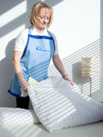 Reinigungskraft bei der Bettenreinigung in einer Praxis